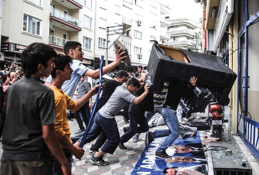 Protesters attack the Soma offices of Turkey’s prime minister Recep Tayyip Erdogan as he visits the mine surrounded by security members on Wednesday 14th May 2014. Photo: Emrah Gurel/AP/Press Association Images