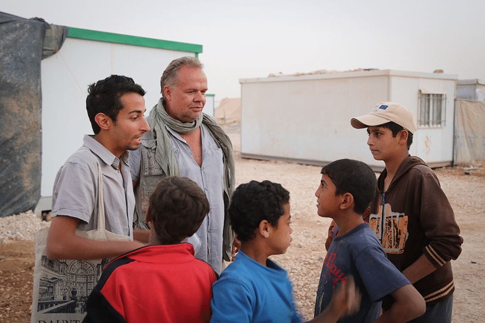 UN official Kilian Kleinschmidt and journalist Sakhr Al-Makhadhi talk to some of Zaatari's younger residents in 2013