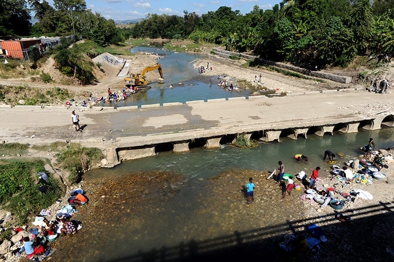 People wash their clothes in a river in Mirebalais. Plans for the development of critical water and sanitation facilities haven’t materialised, meaning people still rely on the same waterways that were responsible for the spread of cholera