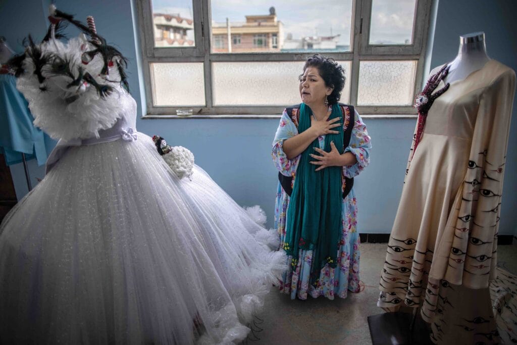 Laila Haidari, who runs the Mother Educational Centre, stands in her ‘atelier’ or dress workshop