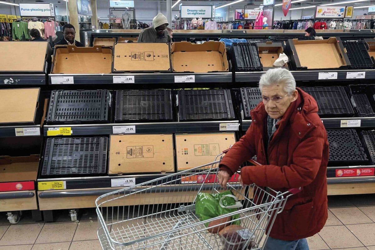 A customer walks past empty shelves at a supermarket in east London, 24th February 2023