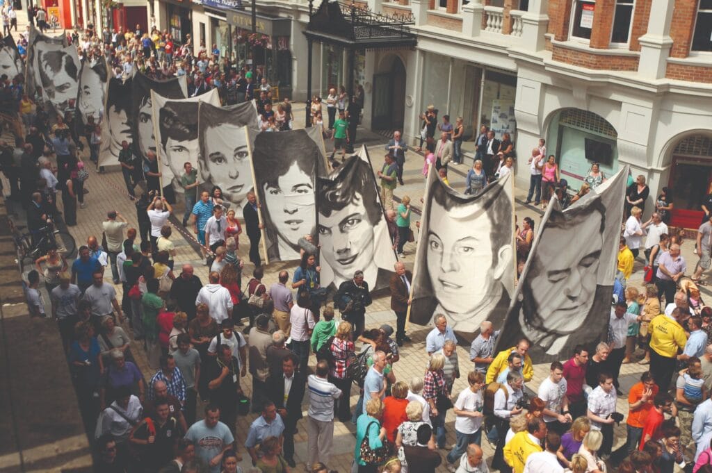 Members of the Bloody Sunday Justice Campaign march with banners depicting the victims of the shootings on their way to the Guildhall in Derry/Londonderry to hear the findings of the Saville Report on 15th June 2010