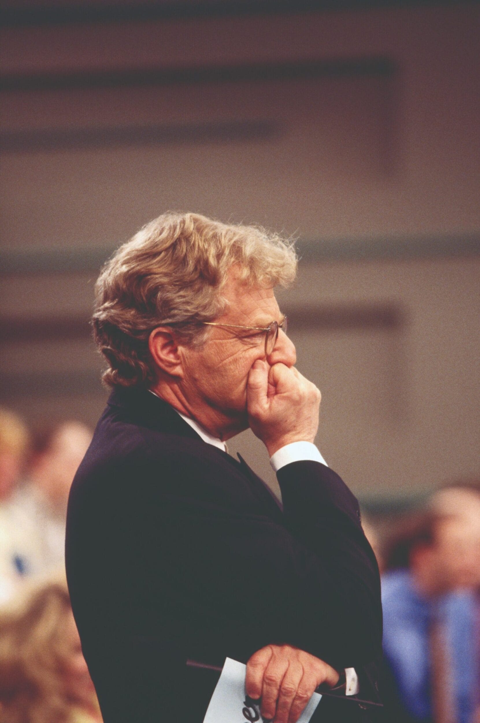 Jerry Springer pauses to listen to his guests during the taping of an episode of The Jerry Springer Show