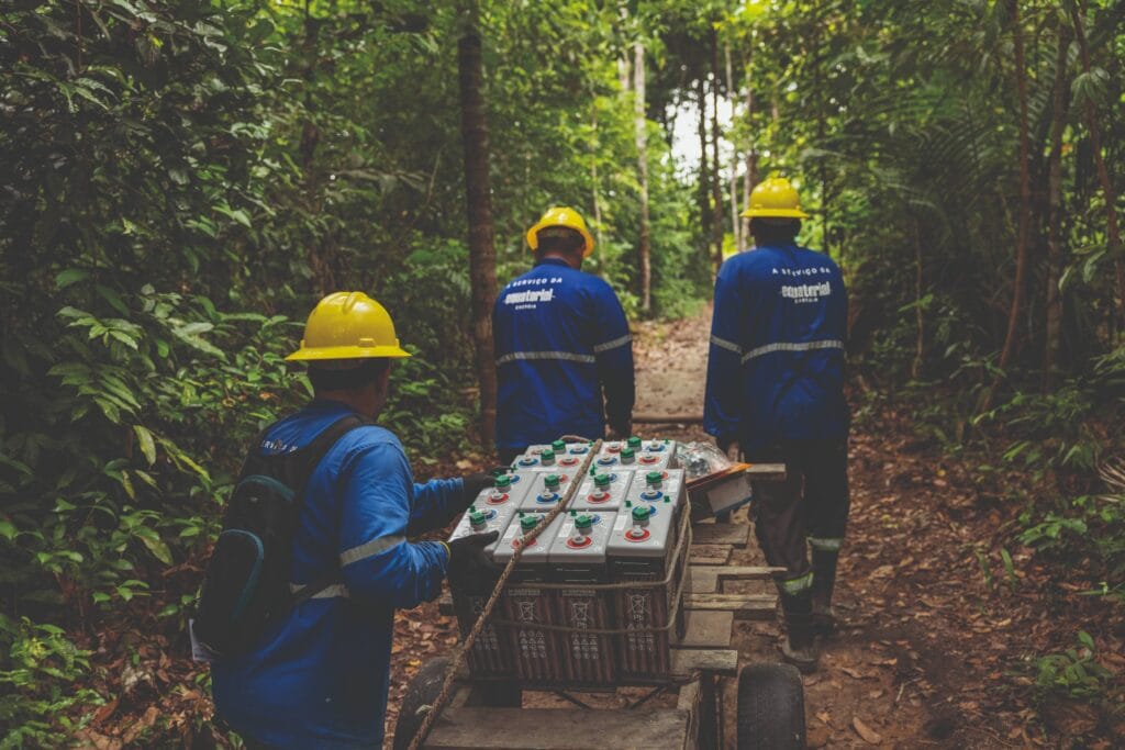 Batteries and other equipment are transported through the Amazon rainforest to a remote community located on Marajó Island where they will be installed, providing reliable access to electricity