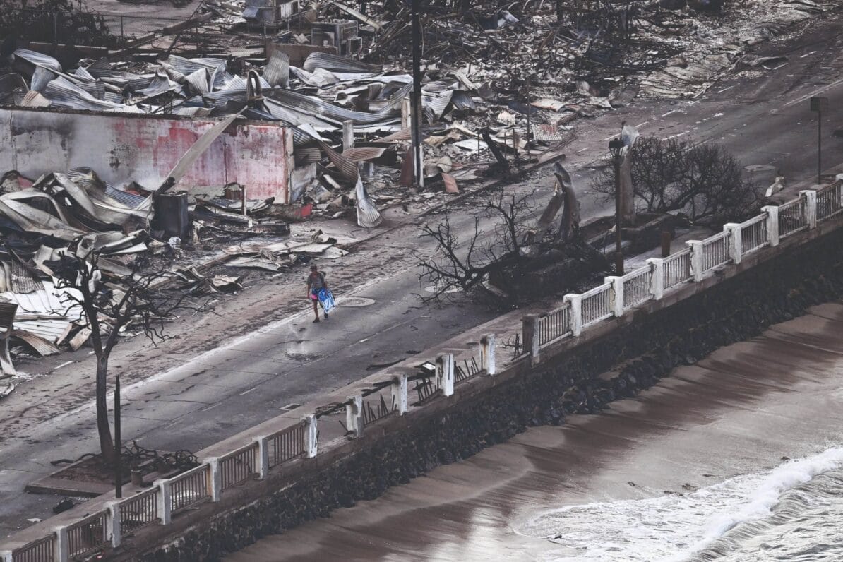 A person walks past destroyed buildings on Front Street, Lahaina, on 10th August 2023, two days after wildfires devastated the town